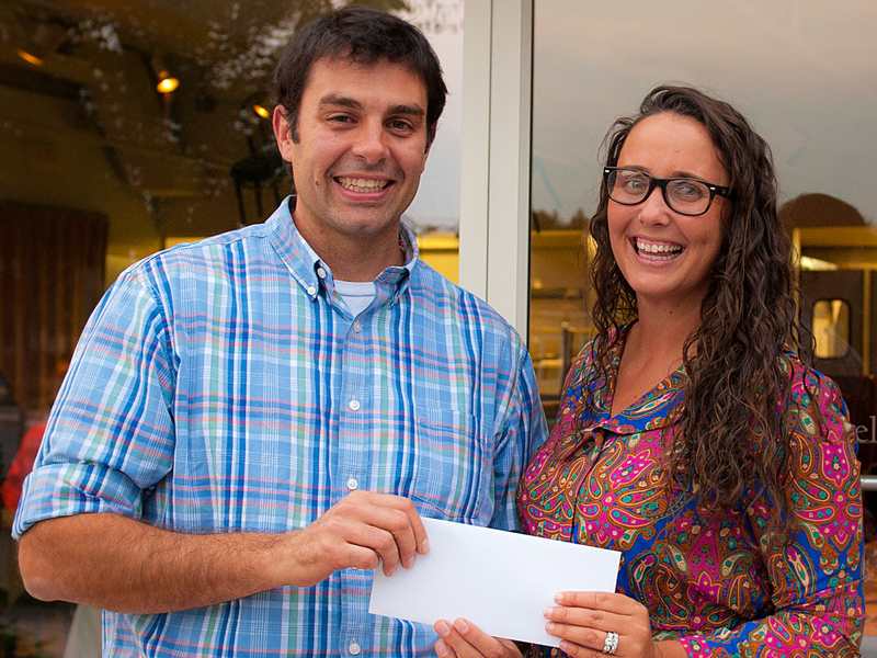 Mike Dickinson, director of operations for the Matt Haley Companies, presents a check for $500 to Bridget Colburn, a teacher at Cape Henlopen High School and longtime employee of Lupo di Mare in Rehoboth Beach. Colburn is one of 15 teachers who received grants for school supplies from MHC, which owns Lupo di Mare and seven other beach-area restaurants. SOURCE SUBMITTED